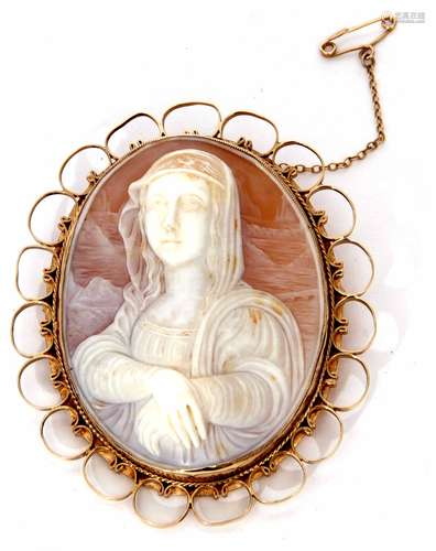 An oval carved shell cameo depicting a head and shoulder profile of a lady, framed in an ornate