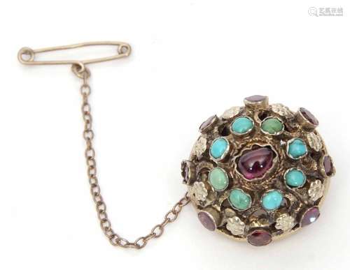 Austro-Hungarian gilt garnet and turquoise brooch, a high dome hollow shape, embellished with scroll