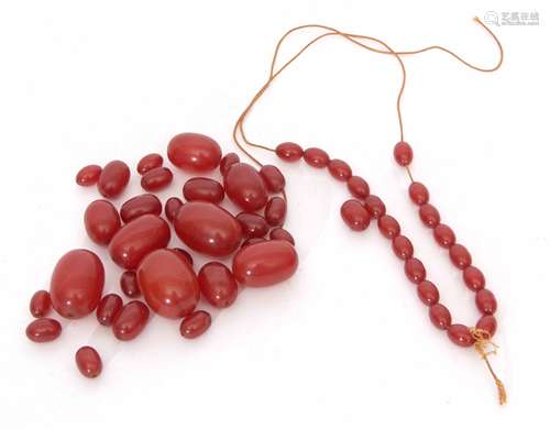 A cherry amber broken bead necklace of graduated size, 1cm - 3cm, 74gms gross weight