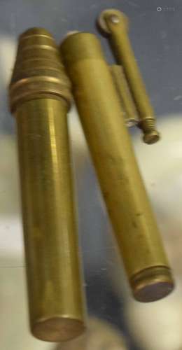 Two brass cigarette lighters of cylindrical form, 8cm long