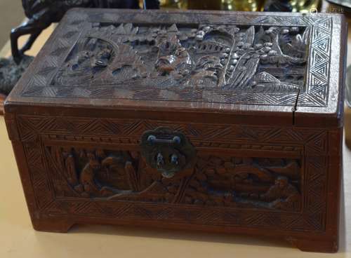 Oriental hardwood box, the lid, front and sides and back all carved with decorative panels enclosing