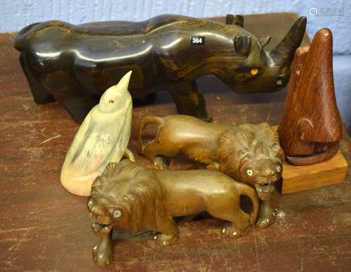 Various hardwood carved models of a rhino, two lions, carved horn model of a bird and one other