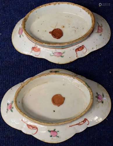 Two shaped Chinese porcelain dishes with polychrome design of figures beside a table, the border