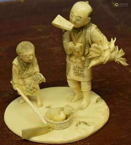 Japanese ivory group, Meiji period, modelled as a Japanese man and boy harvesting vegetables, the