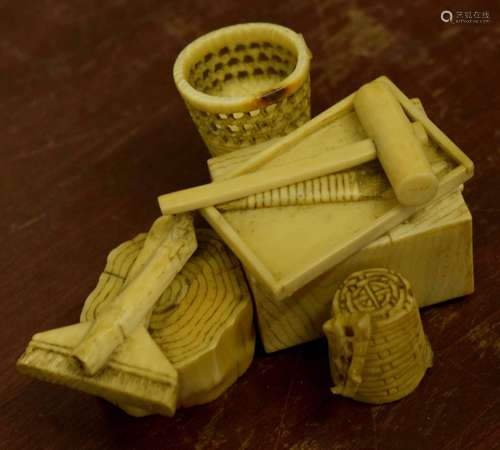 Group of small ivory wares modelled as implements including a small hammer and a wicker basket,