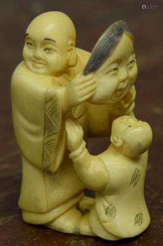 Early 20th century ivory Inro modelled as man holding a lady's face with child below, 5cm high