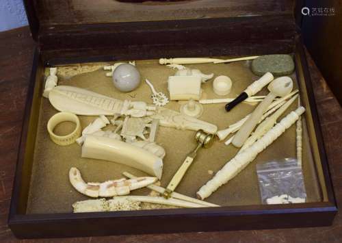 Wooden box containing various carved ivories, early 20th century, including a model of a gavel