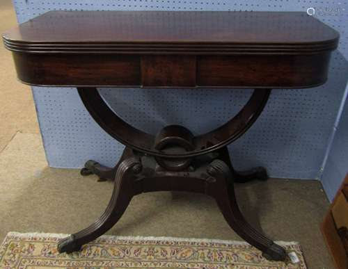 Regency period mahogany tea table, the folding and swivelling top raised on curved supports