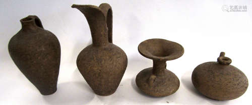 Group of Middle Eastern style pottery wares comprising three ewers and a small vase with lug