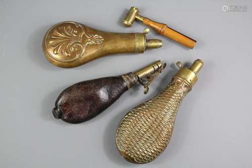 An Assortment of Powder Flasks; the lot includes a leather and brass flask, brass flask and and copper and brass flask, together with a G& JW Hawskley powder measure