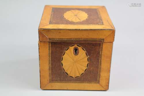 An Antique Satin and Fruit Wood Tea Caddy; the caddy depicting a shell motif to top and side with decorative inlay, in the Sheraton-style, approx 13 x 13 x 13 cms