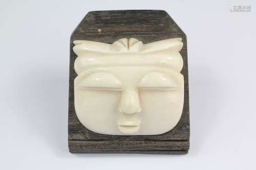 A Carved Pre-1947 Ivory Mask; the mask mounted on a ebony stand, approx 6 x 6 cms