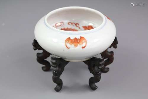 A Chinese Porcelain Tea Bowl, the bowl finely painted with a chasing dragon, the bowl exterior painted with bats, approx 12 cms dia x 5 cms h, with a rosewood display stand, red character marks to base