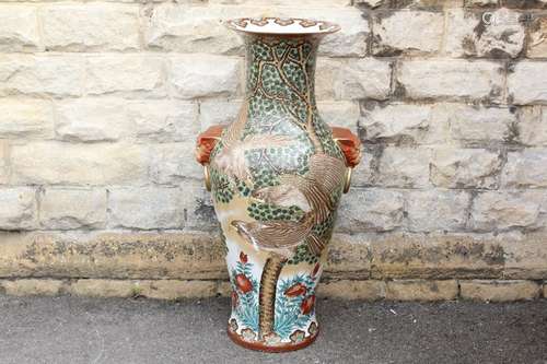 An Impressive Chinese Temple Vase, the vase depicting swooping eagles and having lion mask handles, approx 110 x 38 cms, supported on a circular wooden stand