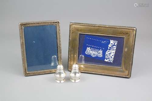 Two Robert Carr Silver Photo Frames, Sheffield hallmark dated 1992 and 1996 respectively, approx 15 x 11 cms and 18 x 14 cms, together with a silver salt and pepper Birmingham hallmark dated 1990