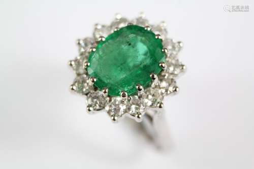 An 18ct White Gold Emerald and Diamond Cluster Ring