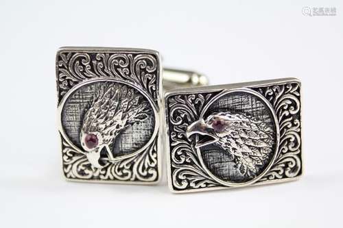 A Pair of Silver Cufflinks, with an image of a bird of prey