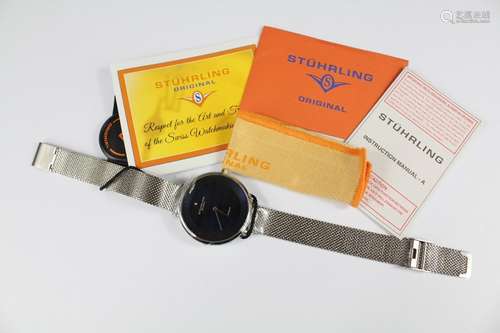 A Stuhrling Stainless Steel Wrist Watch, with blue enamel face, complete with original paperwork and guarantee card