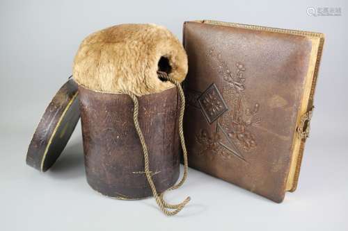 A Victorian Fur Muffler; measuring approx 20 x 18 cms, with neck cord, in the original box together with a charming leather Jewellery Box, modelled as Victorian Album, the cover beautifully decorated with flowers, brass clasp to the side, approx 27 x 32 x 8 cms
