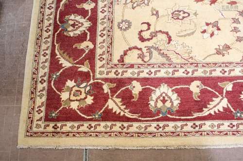 A Large Wool Persian Carpet, the carpet having a cream ground with a foliate terracotta design, approx 250 x 350 cms