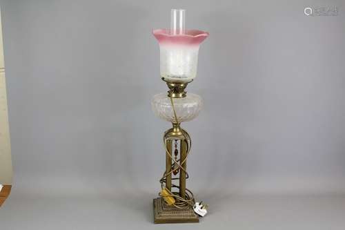 A Victorian Four Pillar Corinthian Oil Lamp; the cut-glass lamp approx 78 cms in h, together with two glass shades and funnels