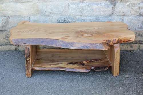 A Natural Hewn Ash Coffee Table, with a polished finish, approx 125 x 65 cms at it's widest point and a lower tier