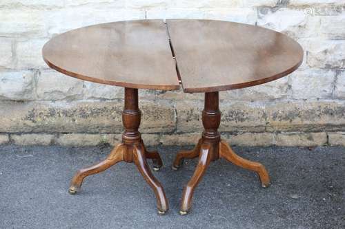 A Late Georgian Oak Oval Dining Table, on a twin-pedestal base, approx 165 x 120 cms, with an additional leaf