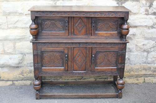 An Antique Oak Court Cupboard, with decorative carving with four cupboards, approx 109 w x 108 h x 38 d cms