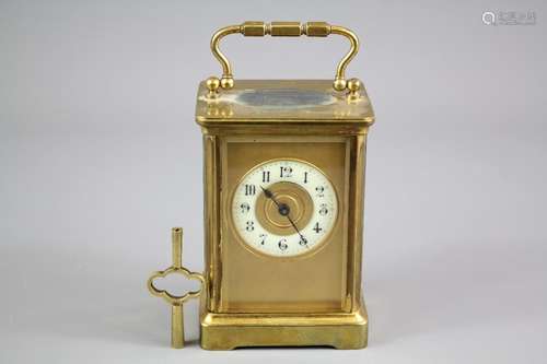 An Antique Brass Carriage Clock; the clock having gilded face with enamel face, numeric dial, Swiss movement, approx 14 x 8 cms, complete with key