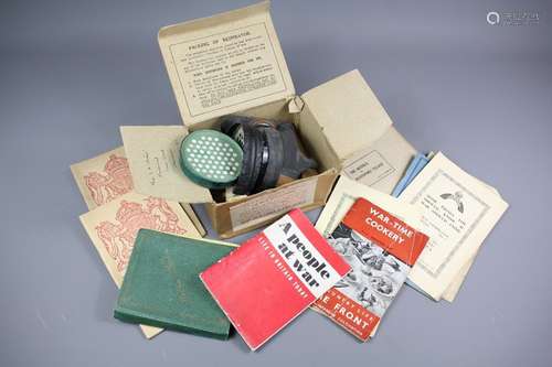 A Boxed WWII Gas Mask, together with a quantity of WWII Instruction Booklets in the event of war, including 'The Defense of Bloodford Village by Col