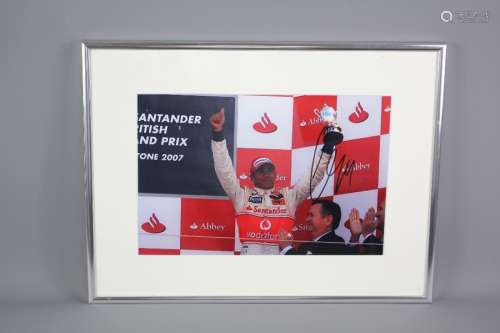 A Signed Photograph of Formula One Champion Lewis Hamilton after winning the British Grand Prix