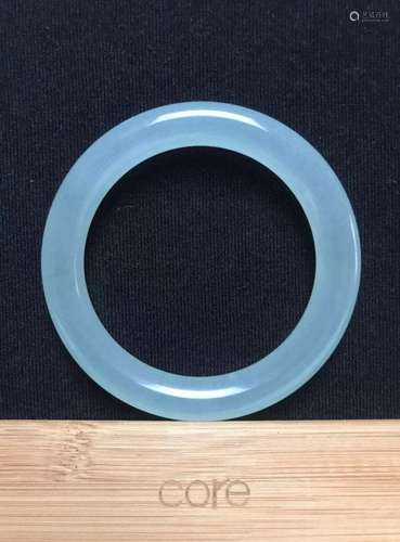 A celadon green jade bangle