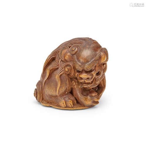 A wood netsuke of a seated shishiEdo period (1615-1868), 19th century Sato Masayoshi (1819-1865)