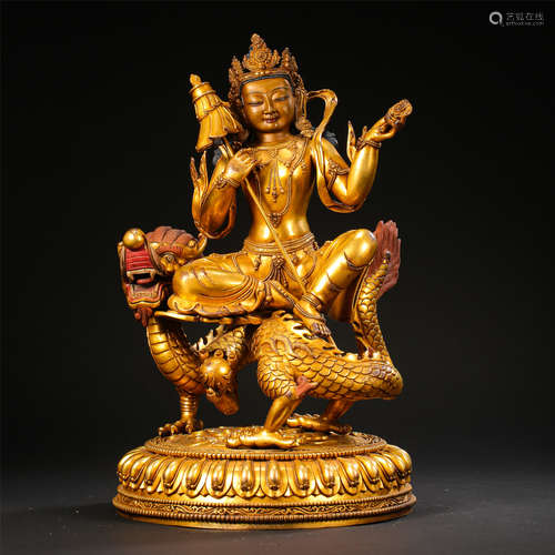 TIBETAN GILT BRONZE SEATED BUDDHIST GUARDIAN ON DRAGON