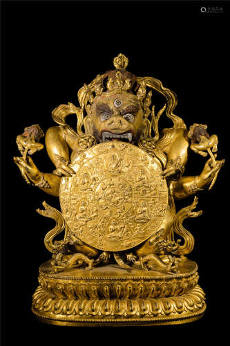 TIBETAN GILT BRONZE STANDING BUDDHIST GUARDIAN WITH SIX REALMS OF THE LIFE ROUND PLAQUE