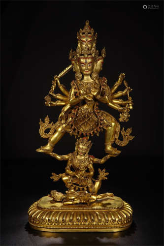 TIBETAN GILT BRONZE STANDING EIGHT ARM BUDDHIST GUARDIAN