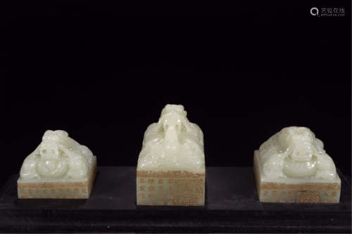 THREE CHINESE WHITE JADE DRAGON SEALS IN CASE