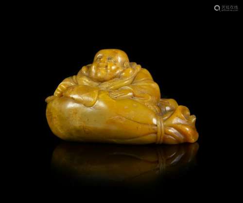 A Carved Soapstone Figure of a Laughing Buddha Length 4
