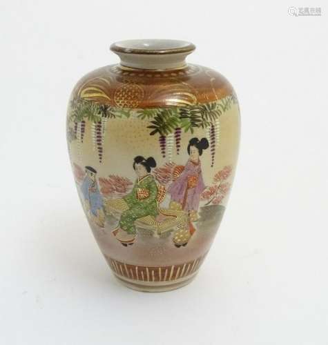A small Japanese satsuma vase depicting figures in a