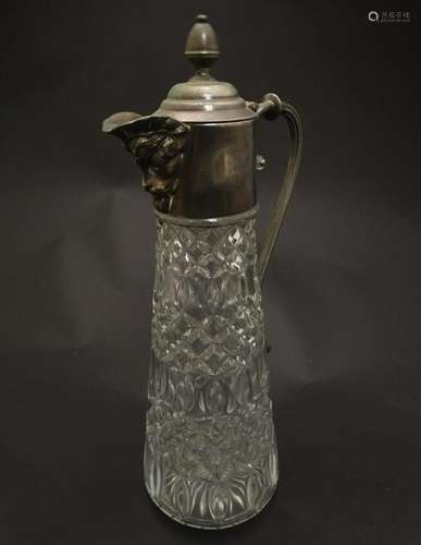 A glass claret jug  with silver plate handle and mounts