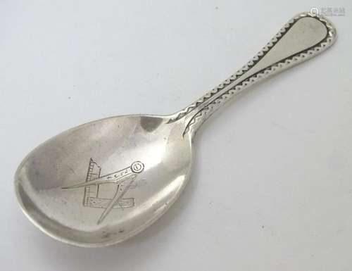 A silver caddy spoon having engraved Masonic symbols to