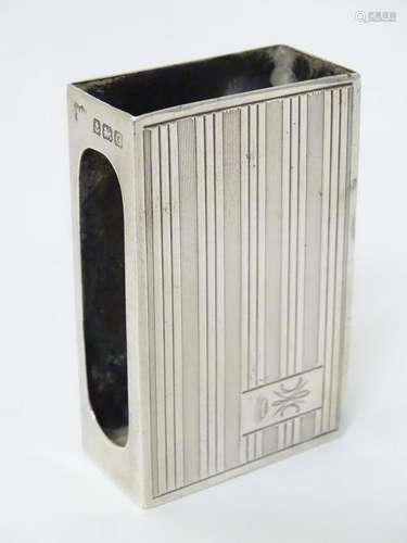 A silver matchbox cover with engine turned decoration.