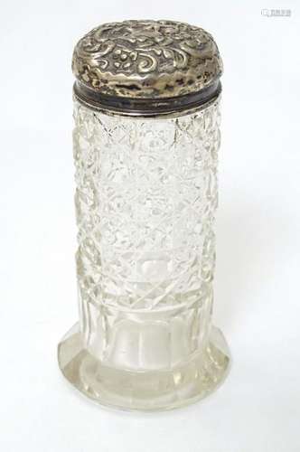 A cut glass dressing table jar with silver top