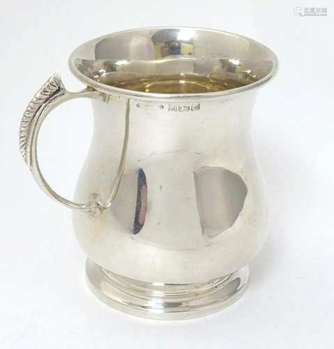 A silver mug hallmarked Birmingham 1975 3 1/2'' high