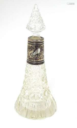 A cut glass scent / perfume bottle with silver collar.