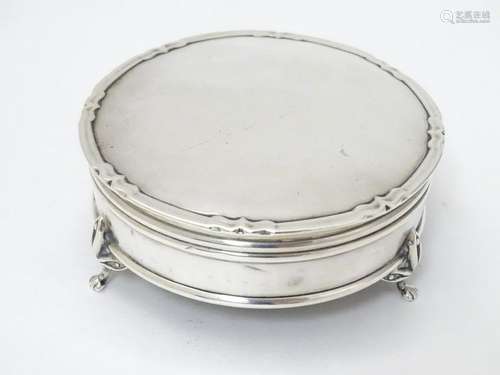 A silver ring box  of circular form on 3 feet,