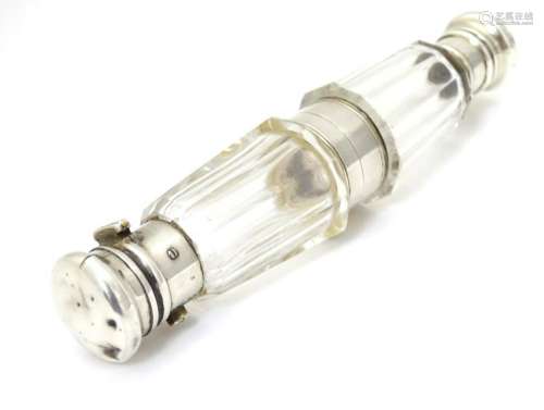 A facet cut glass double end scent  bottle with silver