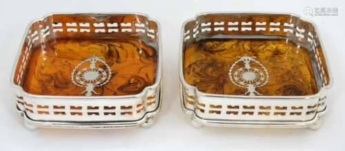A pair of silver plate coasters with faux tortoiseshell