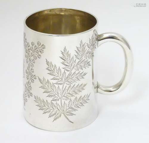A Victorian silver mug with fern decoration hallmarked
