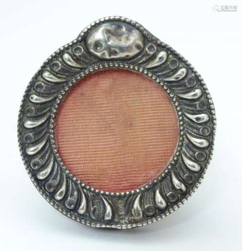 A miniature photograph frame with silver surround.